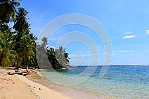 Young beautiful woman enjoying her time and resting close to the sea in the southern beach of Pelicano Island, Panama.