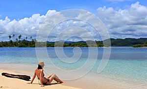 Young beautiful woman enjoying her time and resting close to the sea photo