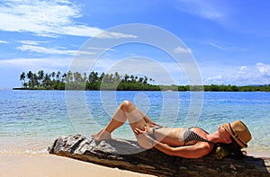 Young beautiful woman enjoying her time and resting close to the sea photo