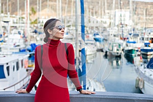 Young beautiful woman enjoying summer vacation in a small fishing port of Puerto de Mogan, Gran Canaria, Spain