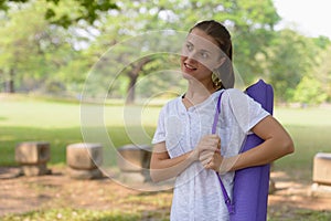 Young beautiful woman exercising at the park outdoors