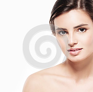 Young beautiful woman face close-up beauty portrait with healthy nature skin and perfect make-up