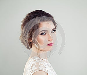 Young beautiful woman face closeup portrait. Perfect makeup, bridal hairstyle