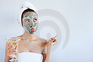 Young beautiful woman in face mask of therapeutic blue mud. Spa