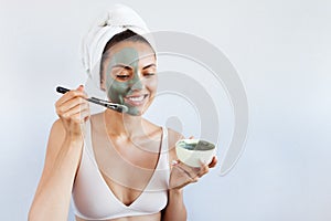 Young beautiful woman in face mask of therapeutic blue mud. Spa