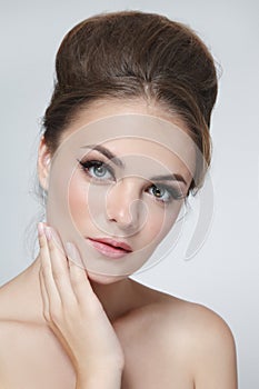 Young beautiful woman with fancy hair bun and natural makeup