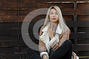 Young beautiful woman in a fashion season beige jacket