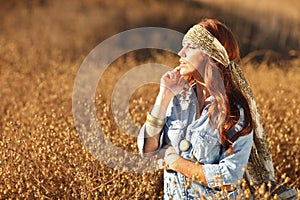 Young Beautiful Woman on a Field in Summer Time