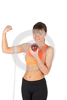 Young beautiful woman after fitness time and exercising with red apple
