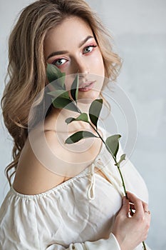 a young beautiful woman with a flower in her hands. Fashion portrait close-up