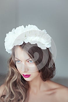 Young beautiful woman with flowers in hair and blue eyes