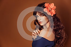 Young beautiful woman with flowers in her hair and makeup, toning photo