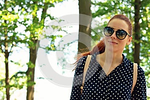 Young beautiful woman with in a forest having a break