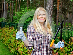 Young beautiful woman gardening and trimming