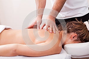 Young beautiful woman getting back massage