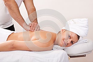 Young beautiful woman getting back massage