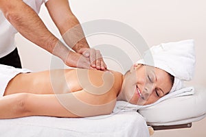 Young beautiful woman getting back massage