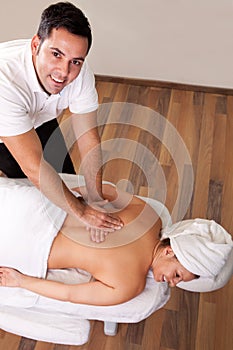 Young beautiful woman getting back massage