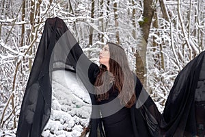 Young beautiful woman girl ballet presents herself in snowy winter forest