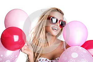 Young beautiful woman with glasses holding pink balloons, valent
