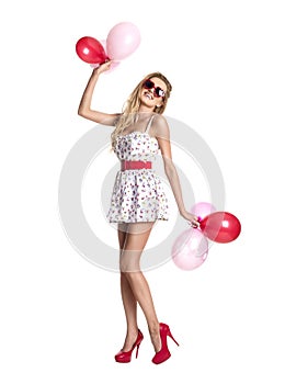 Young beautiful woman with glasses holding red pink balloons, va