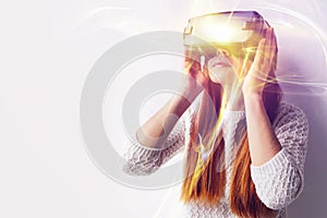 A young beautiful woman in glasses of virtual reality saw something amazing. Modern technologies.