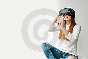 A young beautiful woman in glasses of virtual reality saw something amazing. Modern technologies.
