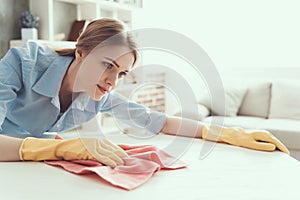 Young Beautiful Woman in Gloves Cleaning House