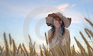 beautiful woman on golden cereal field in summer