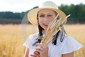 Young beautiful woman in golden wheat field. concept of summer, freedom, warmth, harvest, agriculture