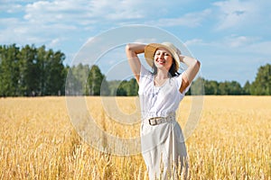 Young beautiful woman in golden wheat field. concept of summer, freedom, warmth, harvest, agriculture