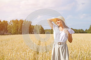 Young beautiful woman in golden wheat field. concept of summer, freedom, warmth, harvest, agriculture