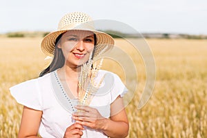Young beautiful woman in golden wheat field. concept of summer, freedom, warmth, harvest, agriculture