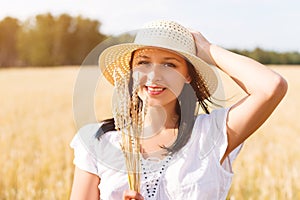 Young beautiful woman in golden wheat field. concept of summer, freedom, warmth, harvest, agriculture