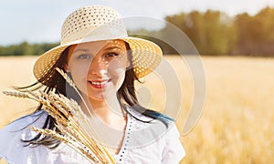 Young beautiful woman in golden wheat field. concept of summer, freedom, warmth, harvest, agriculture