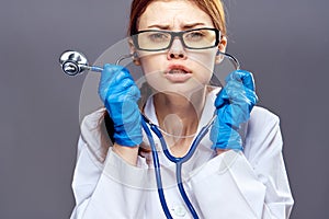 Young beautiful woman on Gray background, doctor, scientist, medicine