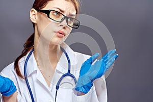 Young beautiful woman on a gray background, medicine, doctor