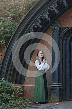 Young beautiful woman in green medieval dress