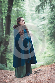 Young beautiful woman in green medieval dress