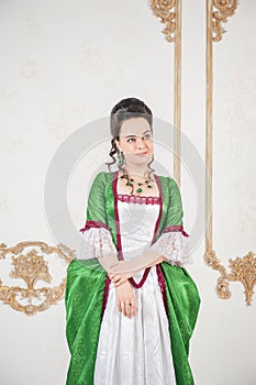 Young beautiful woman in green rococo style medieval dress