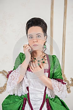 Young beautiful woman in green rococo style medieval dress