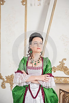 Young beautiful woman in green rococo style medieval dress