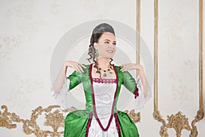 Young beautiful woman in green rococo style medieval dress