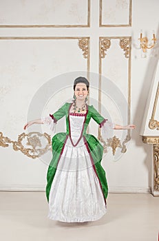 Young beautiful woman in green rococo style medieval dress