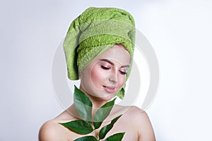 Young beautiful woman with a green towel on her head