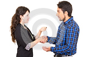 Young beautiful woman handing over key to man