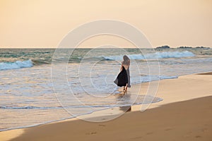 Young beautiful woman has fun at the ocean in summertime