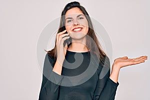 Young beautiful woman having a conversation talking on smartphone ove isolated background very happy and excited, winner