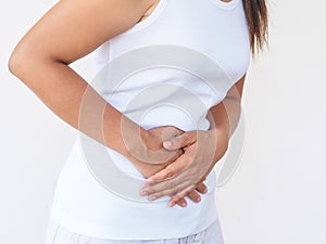 Young beautiful woman having painful stomachache on white background.Chronic gastritis. Abdomen bloating concept.