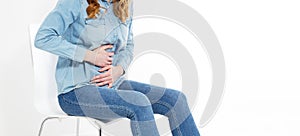 Young beautiful woman having painful stomachache on white background. Chronic gastritis. Abdomen bloating concept